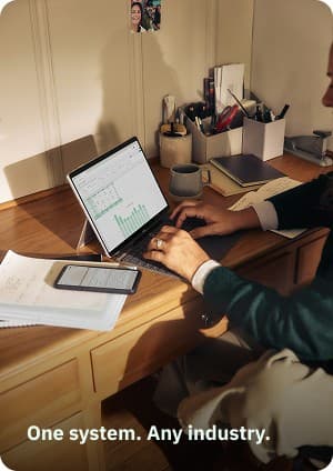 Laptop showing a spreadsheet dashboard on a home-office desk